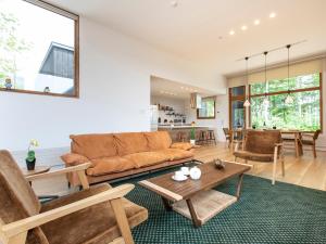 a living room with a couch and a table at Birchwood Chalet in Niseko