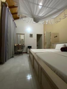 a large bedroom with a large bed and a desk at Vista House Kandy in Kandy