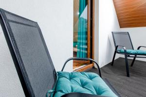 a television sitting on a balcony with a chair at Molo Resort in Niechorze