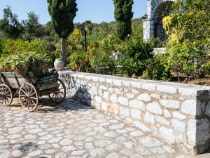 una pared de retención de piedra con un carro con plantas en MELITI, en Skoutari