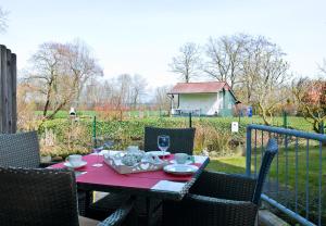 a table with glasses of wine on a patio at Strandglück in Insel Poel