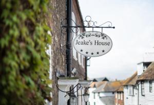 a sign for a ladies house hanging on a building at Jeakes House in Rye