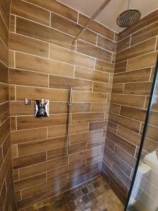 a bathroom with a shower with wooden walls at Swallow cottage, Over Kellet in Over Kellet +65 photos