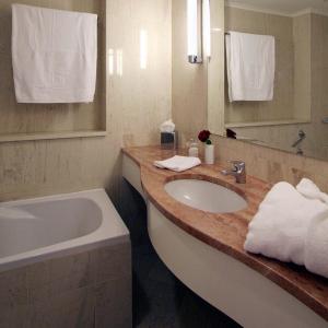 a bathroom with a tub and a sink and a bath tub at AKS Hinitsa Bay in Porto Heli