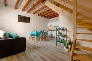 a living room with a table and a couch at Molo Resort in Niechorze