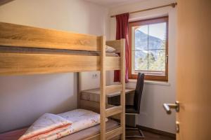a room with two bunk beds and a window at Golserhof Sonne in Cadipietra