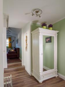 a room with a white cabinet with plants on it at Villa Binz - Apt. 03 in Binz