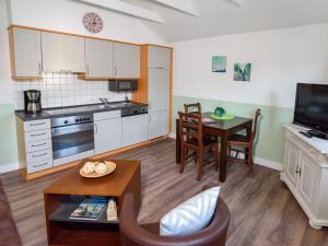 a kitchen with a table and a dining room at Villa Binz - Apt. 03 in Binz