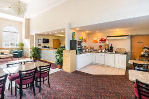 a large room with a kitchen and a table and chairs at Quality Inn in Weston