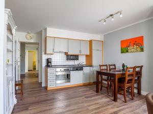 a kitchen and dining room with a table and chairs at Villa Binz - Apt. 01 in Binz