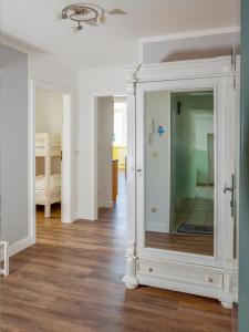 a living room with a large mirror in a room at Villa Binz - Apt. 01 in Binz