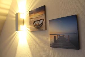 a picture of a pier on a wall with a light at Parkhotel Klüschenberg in Plau am See