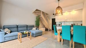 a living room with a blue couch and a table at AZURE Apartament Pobierowo in Pobierowo