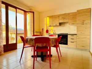 a kitchen with a table and chairs with a view at Dal Mariano in Brenzone sul Garda