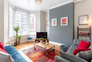 a living room with a couch and a table at Air Host and Stay - Watford house beautiful period house sleeps 5 in Liverpool