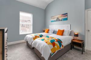 a bedroom with a large bed and a window at Air Host and Stay - Watford house beautiful period house sleeps 5 in Liverpool
