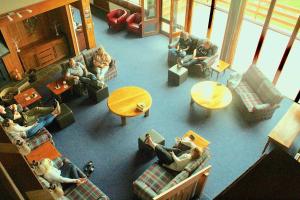 a group of people sitting in a living room at Valhalla Perisher in Perisher Valley