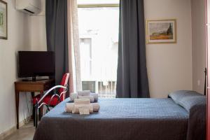 a bedroom with a bed with a teddy bear on it at Callas Room Opera in Catania