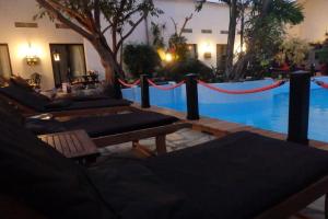 a pool with benches and a red rope around it at Hotel Tropical in Durbuy