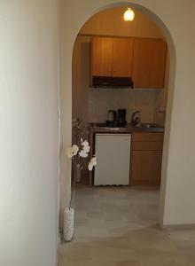 a kitchen with an archway in the middle of a room at Studio Manousos in Plakias