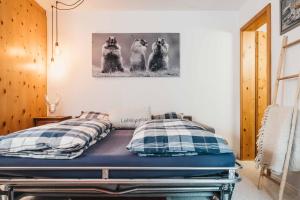 un letto in una camera con foto di tre cani di Charming 4 bed flat in Flims a Flims