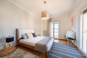 a bedroom with a bed and a blue rug at Frezia Apartment in Corfu