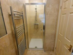 a shower with a glass door in a bathroom at Beverley Central Townhouse Free Parking Sleeps 8 in Beverley +13 photos