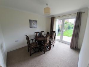 a dining room with a table and chairs and a window at Beverley Central Townhouse Free Parking Sleeps 8 in Beverley