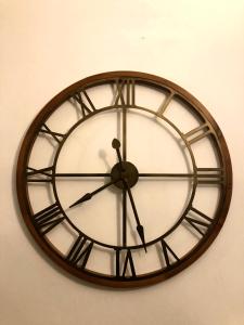 a clock is hanging on a wall at Hotel Nazionale in Florence