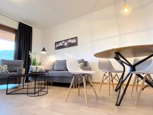 a living room with a couch and a table and chairs at Panorama Home Valča in Stará Turá
