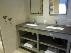 a bathroom with two sinks and a mirror at Clarberg - Gîte in Saint-André-de-Roquepertuis