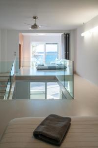 a room with a glass table with a towel on a bench at Seaside Maisonette in Itea in Itea