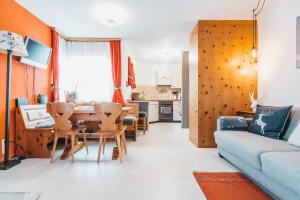 a living room with a couch and a table and chairs at Charming 4 bed flat in Flims in Flims