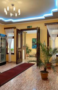 a lobby with a door and a potted plant at Vila A Hotel in Korçë