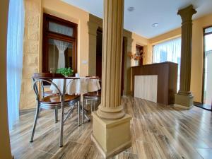 a dining room with a table and chairs at Vila A Hotel in Korçë