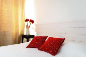 a bedroom with two red pillows on a bed at B&B La Corte San Francesco in Bari