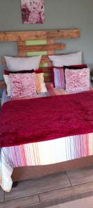 a bedroom with a large bed with a wooden headboard at Lapa la Bakgatlha in Soweto