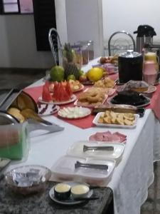 a table with a bunch of food on it at Roda Viva Park Hotel in Jales