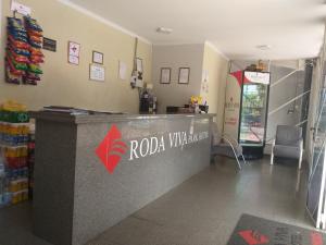 a lobby of a restaurant with a red va virus counter at Roda Viva Park Hotel in Jales
