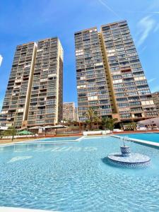 a large swimming pool with two tall buildings at Los Gemelos 2- Aloturin Benidorm in Benidorm