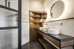 a bathroom with a sink and a mirror at Budapest Eye- Boutique Suites, by BQA in Budapest