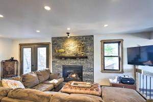 a living room with a couch and a fireplace at Inviting Irma Cottage with Silver Lake Access! in Tomahawk