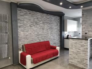 um sofá vermelho num quarto com uma parede de tijolos em CAV Black Pearl by People em Turim