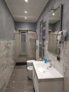 a bathroom with a sink and a toilet and a mirror at CAV Black Pearl by People in Turin