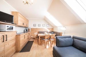 a kitchen and dining room with a table and a couch at Gästehaus Gnant in Winten