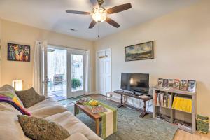 a living room with a couch and a flat screen tv at Charming Charlottesville Apt with Outdoor Space! in Charlottesville
