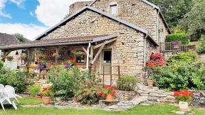 ein Steinhaus mit Blumen davor in der Unterkunft Le Cottage du Château in Chaudenay-le-Château