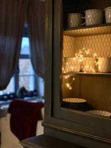 a cabinet with lights in a room with a window at Farm & Country House Gizewo 32 in Sorkwity