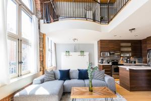 a living room with a couch and a table at Les Lofts St Jean in Quebec City