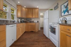 une cuisine avec des appareils électroménagers blancs et des armoires en bois dans l'établissement Gaibler Country Cottage, à Newberg
